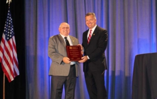 Dick Walsworth receiving his plaque from Jim Mattheson
